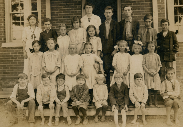 Photo of teacher and students in 1913